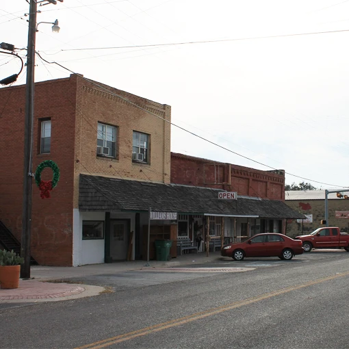 Small town storefronts in Lometa featuring towing service